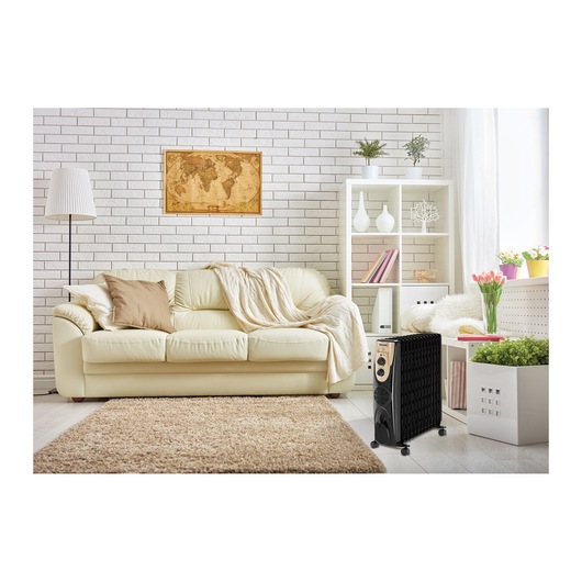 BLACKDECKER OR013FD black oil-filled radiator heater in a modern living room with a cream sofa and decor.