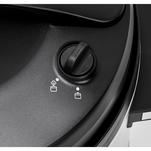 BLACKDECKER PCP1010 pressure cooker control knob close-up, showing two function icons on black surface.