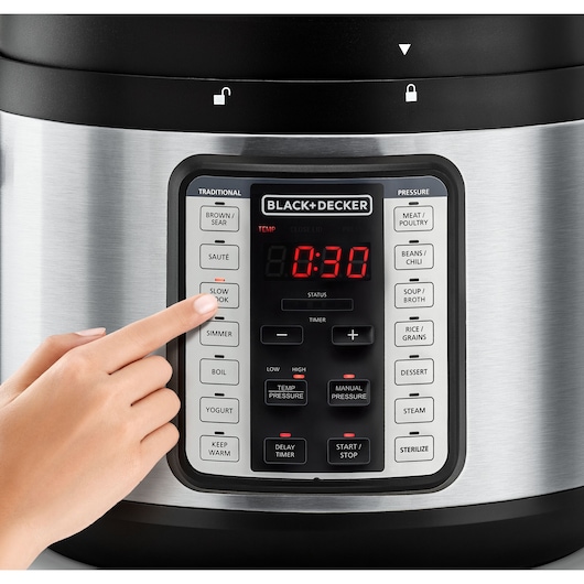 Photo of a hand pressing the SLOW COOK button on a BLACK+DECKER electric pressure cooker, SKU PCP1010, front view.