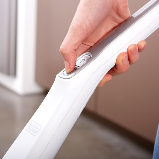Photo of BLACK+DECKER SVFV3250L vacuum cleaner handle with hand pressing power button.