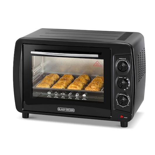 A BLACK+DECKER countertop electric oven with a glass door, showing baked goods inside. The oven features three rotary control knobs for temperature, function selection, and timer settings.
