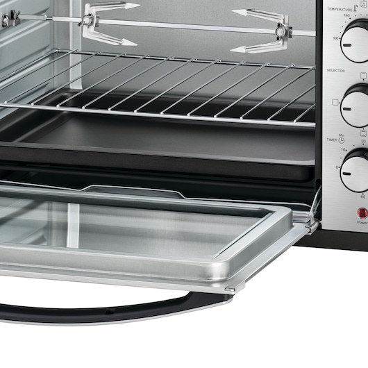 BLACKDECKER TRO50RDG countertop oven with open glass door, wire rack, and baking tray, side control panel visible.