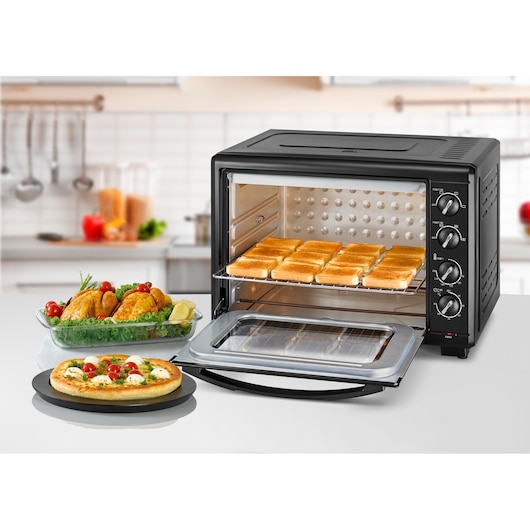 BLACKDECKER TRO55RDG countertop oven with toast, pizza, and roasted chicken, front angle.