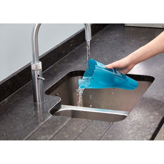 Photo of BLACK+DECKER WDC115WA vacuum cleaner dustbin being emptied into a kitchen sink.