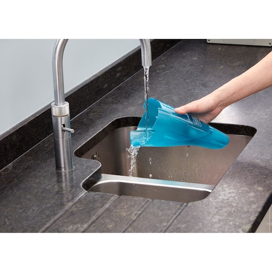 BLACKDECKER WDC215WA vacuum cleaner dust container being emptied into kitchen sink.