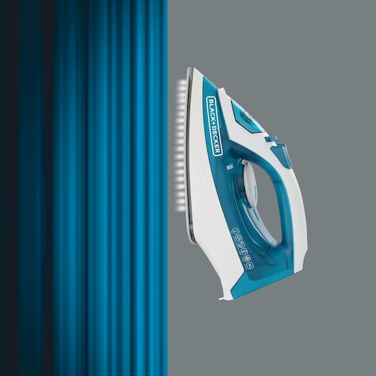 Photo of BLACK+DECKER X1575 steam iron with blue accents pressing a blue shirt, side angle.