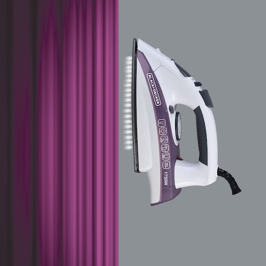 BLACKDECKER X1750 steam iron side view pressing purple fabric, grey background.