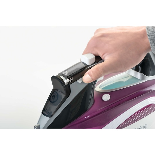 Photo of BLACKDECKER iron X2250, purple body, with hand gripping handle, white background, product close-up.