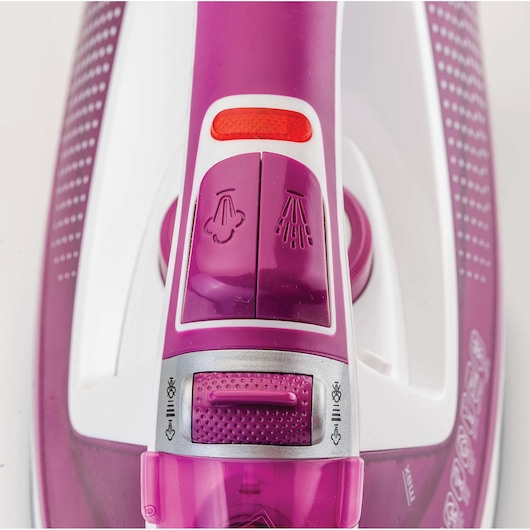 BLACKDECKER X2450 steam iron close-up showing purple and white controls and spray buttons, top view.